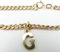 A 9ct gold curb link chain with 9ct gold letter G pendant, 7.1g