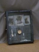 Glazed wall hanging display of lead items including cutlery, lead framed monochrome pictures etc, 82