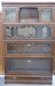 Four tier Globe Wernicke oak bookcase with leaded glass fronts, the top section with central cubby