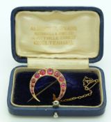 A 9ct gold crescent brooch set with graduated paste and diamonds, in original Cheltenham box