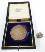 A silver medallion and a Victorian silver locket with horseshoe and crop decoration