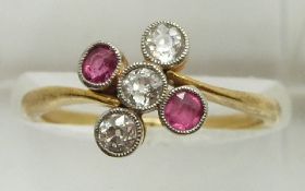 An 18ct gold ring set with three diamonds and two pink sapphires, 2.8g, size N