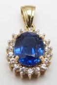 A 9ct gold pendant set with an oval cut kyanite surrounded by diamonds