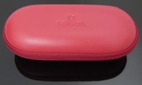 Omega travelling watch case together with a collection of Omega watch parts and a leather strap.