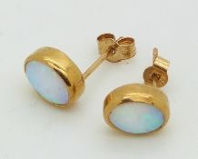 A pair of 9ct gold earrings set with opals