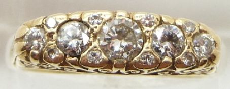 An 18ct gold ring set with five round cut diamonds, the centre diamond measuring approximately 0.
