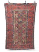 Prayer mat/rug with blue, red and brown checked pattern and intricate border, on a red ground, 142 x