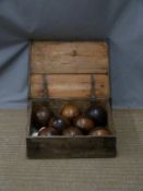 Eight vintage wooden bowls and two jacks in wooden box