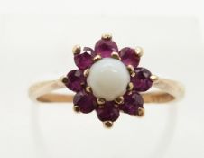 A 9ct gold ring set with an opal and rubies, 2.0g, size M