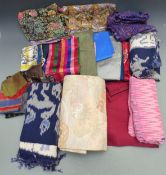 A collection of textiles including Chinese top, Japanese belt, Thai cloth, batiks etc