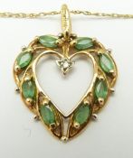 A 9ct gold heart pendant set with marquise cut emeralds and a diamond, in original Brooks &