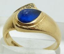 A 14k gold ring set with a blue cabochon and a diamond, size Q, 4g.