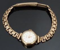 Baume 9ct gold ladies wristwatch with gold hands and hour markers, silver dial and 17 jewel