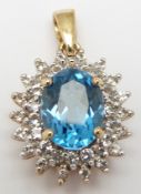 A 9ct gold pendant set with an oval cut topaz surrounded by diamonds