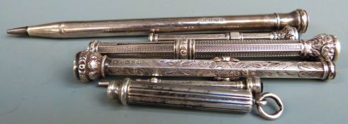 Six hallmarked silver and white metal propelling pencils, some with hardstone finials.