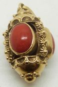 An 18ct gold pendant set with three coral cabochons, 6.7g