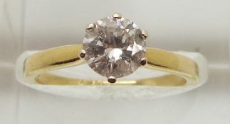 An 18ct gold ring set with a round brilliant cut diamond measuring approximately 1ct, 3.3g, size M