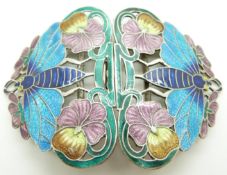 A silver buckle depicting flowers and moths set with enamel