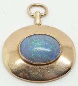 A yellow metal pendant set with an oval opal cabochon, 3.3 x 3.9cm