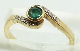 A 9ct gold ring set with an emerald and diamonds, 2.2g, size N