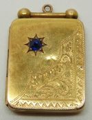 Art Deco 15ct gold rectangular locket set with a sapphire in a star setting and with engraved