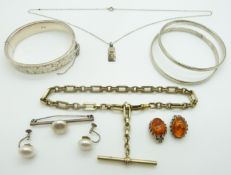 Three silver bangles, silver fob chain, pressed amber earrings and silver ingot