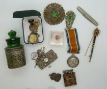 A collection of bijouterie items including brooches, a hallmarked silver mounted glass container,