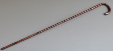 A bamboo walking stick with silver mounts