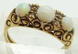 A 9ct gold ring set with opal cabochons, 3.6g, size N