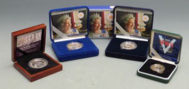 Four cased silver commemorative coins, two being proof examples, all with certificates