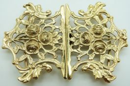 A silver gilt buckle decorated with roses