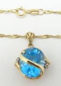 A 9ct gold necklace set with a blue topaz and diamonds, 4.1g