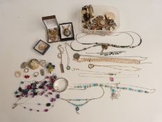 A collection of costume jewellery including silver bangle, silver ingot, silver necklaces etc