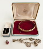 A silver charm bracelet, silver ring set with marcasite and a rolled gold bangle