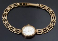 Swiss 9ct gold ladies wristwatch with gold hands and baton markers, silver dial and quartz movement,
