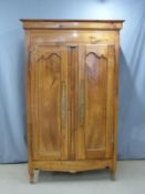 French fruitwood armoire with shaped and panelled doors and pegged joints, W131 x D54.5 x H214cm