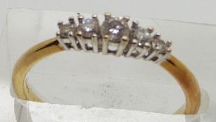 An 18ct gold ring set with five diamonds, 2.6g, size O