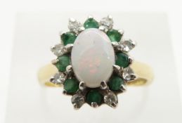 An 18ct gold ring set with an opal cabochon, emeralds and diamonds, 4.8g, size M