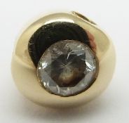 An 18ct gold pendant set with a round cut diamond measuring approximately 0.18ct, 0.9g