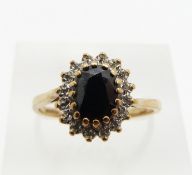 A 9ct gold ring set with a sapphire and diamonds, 2.6g, size P