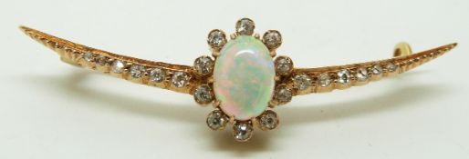 A late Victorian crescent shaped brooch set with an oval opal cabochon and diamonds, in original