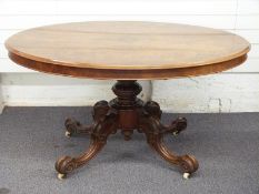 Victorian walnut and figured walnut oval breakfast table, the tilting top with quartered figured