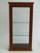 An oak glass display cabinet with two adjustable glass shelves approximately, 38 x 26 x 77cm
