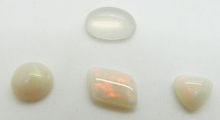 Three loose opal cabochons and a loose moonstone cabochon