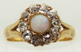 Victorian 18ct gold ring set with an opal cabochon surrounded by old cut diamonds, size J, in
