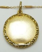 A 9ct gold necklace (2.5g)and Victorian locket with engine turned decoration and textured border,