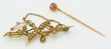 Victorian stick pin set with topaz and an Edwardian 9ct brooch in the form of a swallow set with