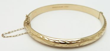 A 9ct gold bangle with cut out decoration, 8.3g