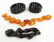 Two jet bracelets, tortoiseshell bracelet and amber buttons