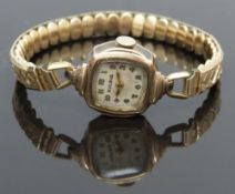 Bulova gold plated ladies wristwatch with gold hands and Arabic numerals, silver dial and signed